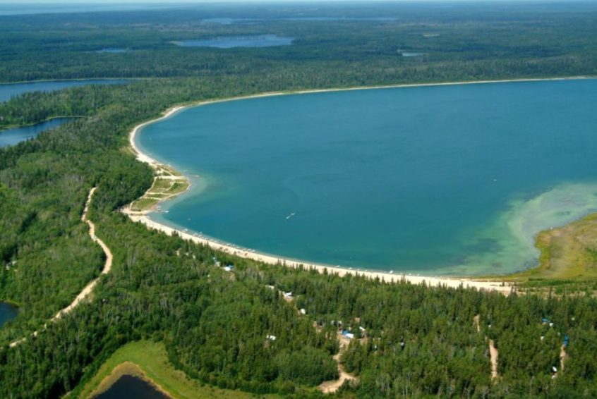An aerial photo of a lake and forest.