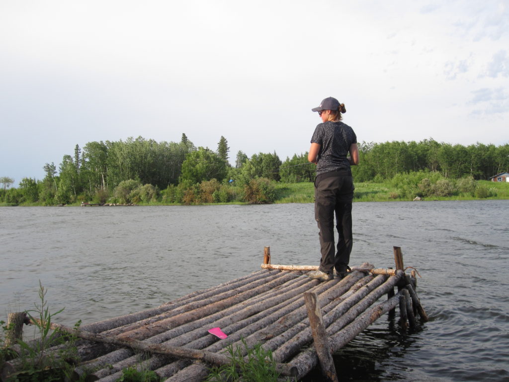 Sarah Schmid fishing off the dock at a lake